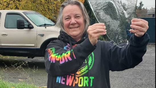 Lisa, Chief Cook of Refreshing Pro Wash, standing at a local Eugene business, showcasing our top-tier pressure washing services in Eugene, Oregon, and commitment to community care.